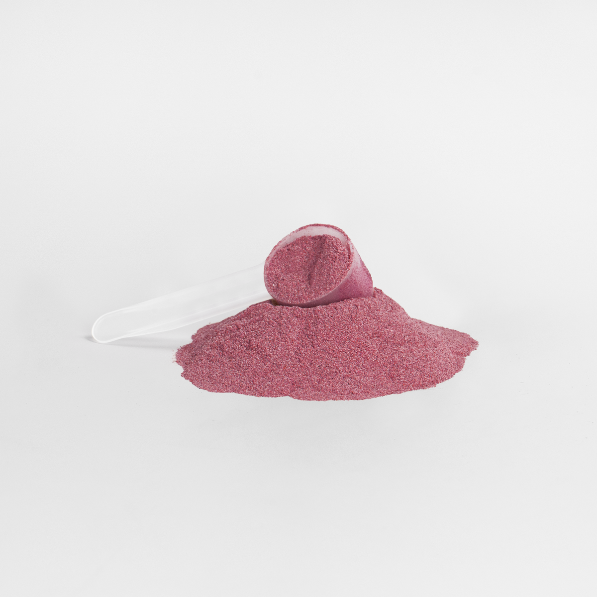Close-up of red-purple FIT APE Beetroot Powder and a measuring scoop