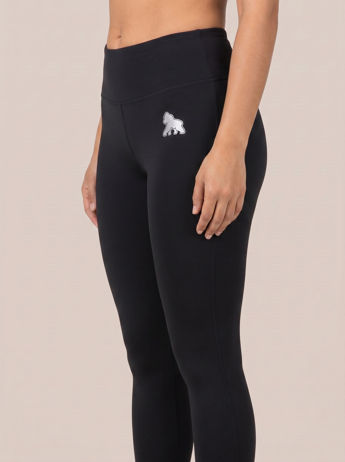 Black FIT APE women's high-waist leggings, close-up angled view of waist and hip