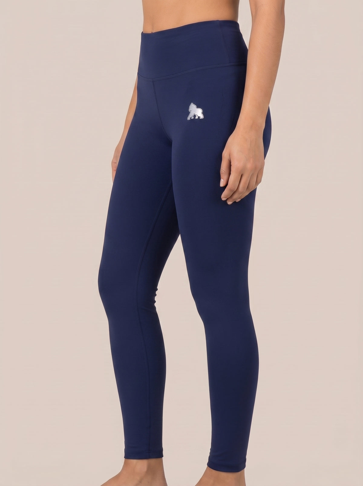 Navy FIT APE women's high-waist leggings, angled front view on a model