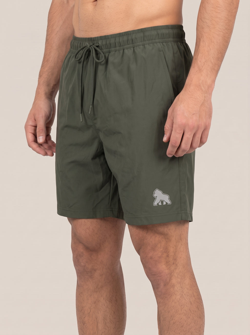 Olive FIT APE men's performance shorts on a model, angled front view
