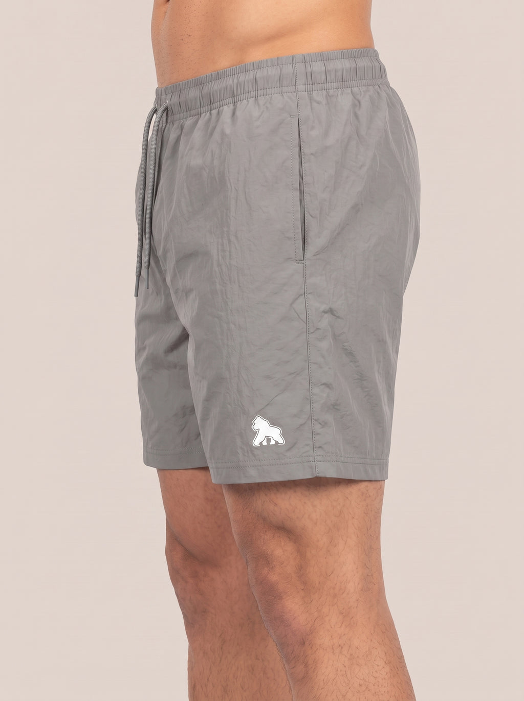 Gray FIT APE men's performance shorts on a model, side view