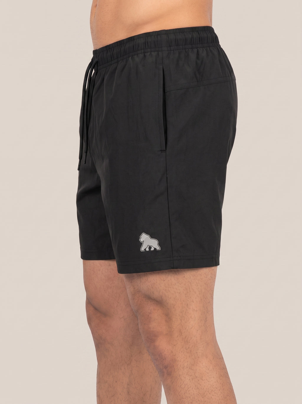 Black FIT APE men's performance shorts on a model, side view