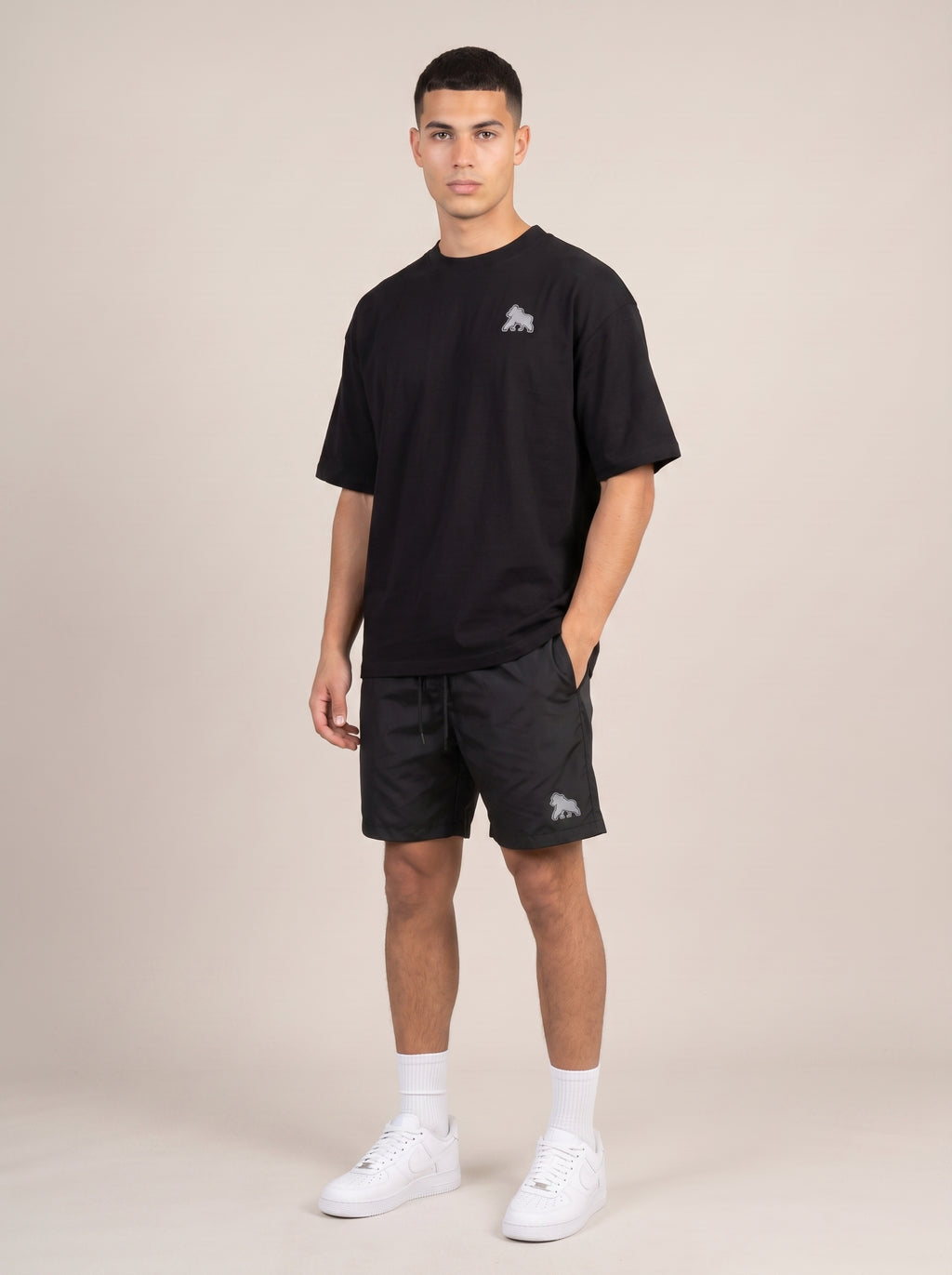 Black FIT APE men's oversized tee on a model, angled front view