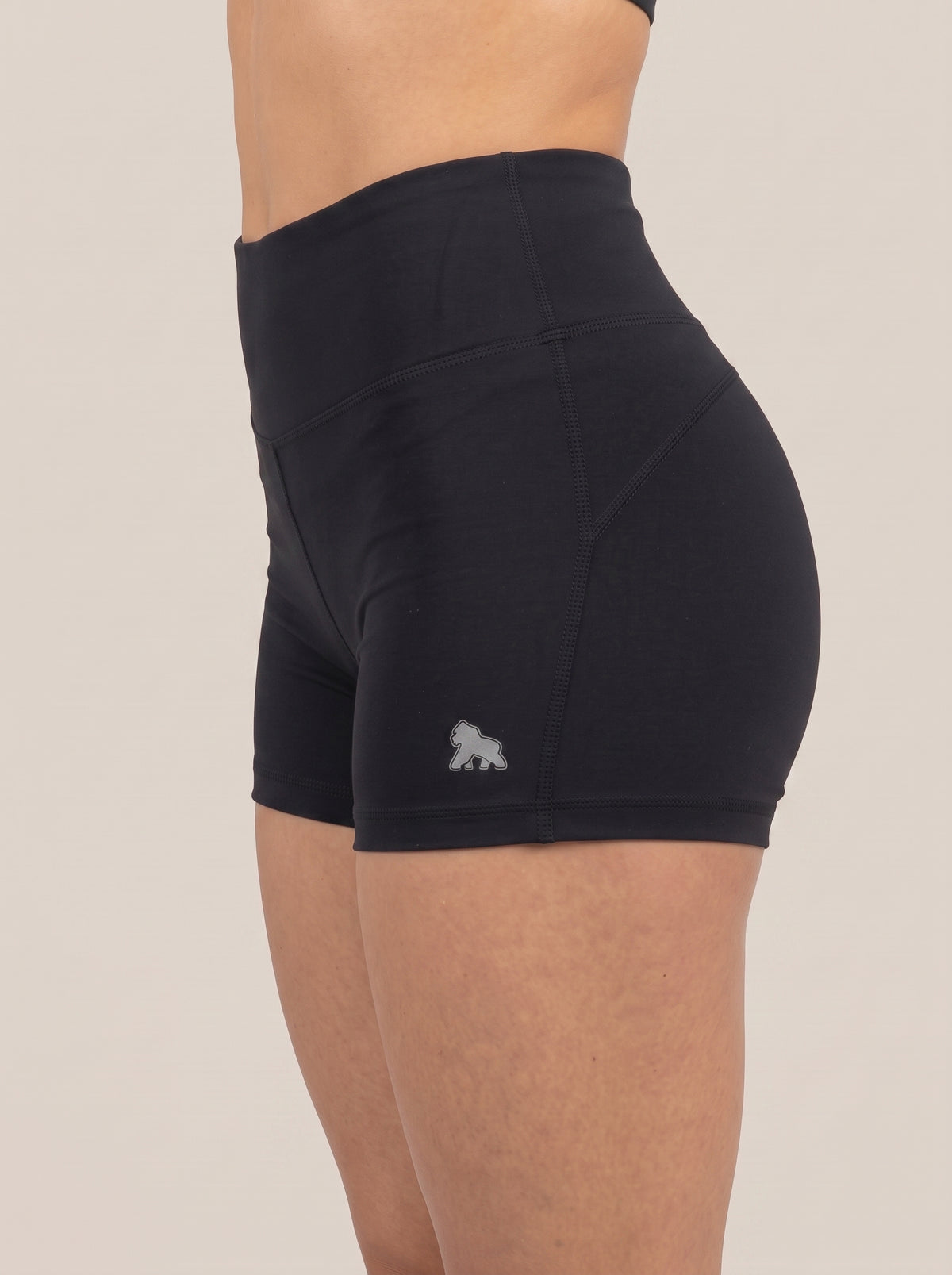 Black FIT APE women's fitted shorts with white hip gorilla, side view