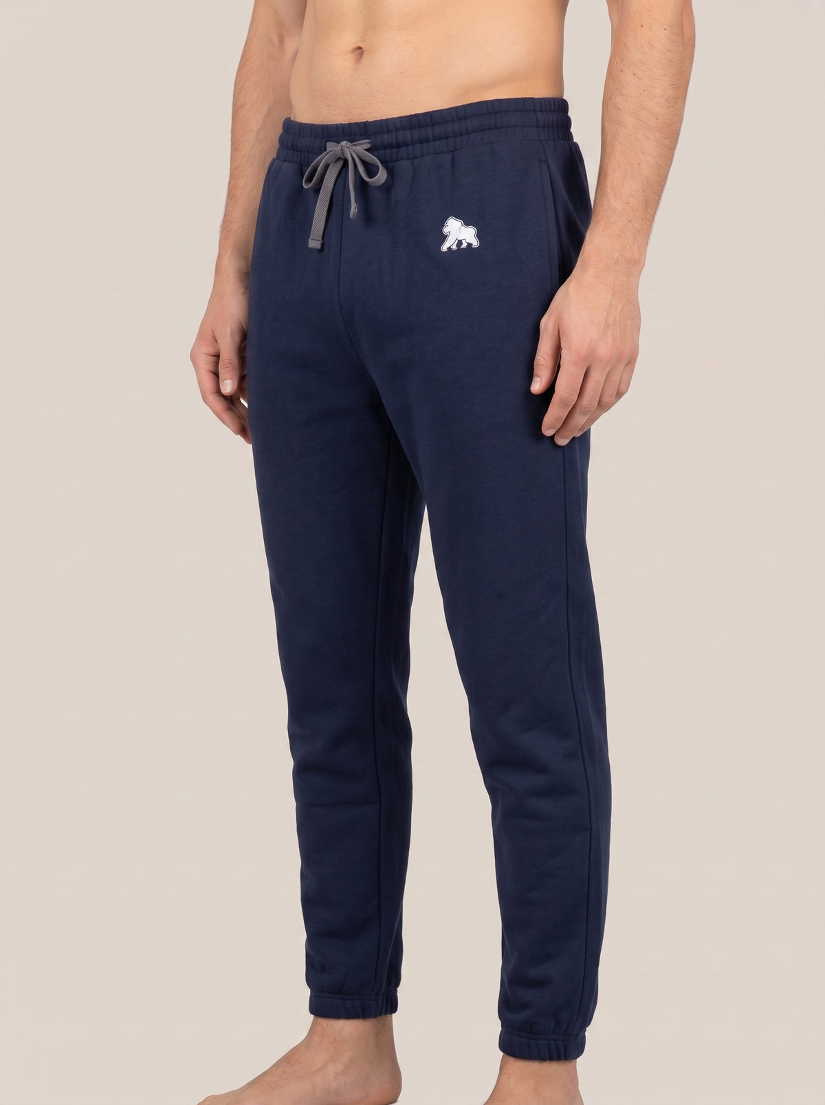 Navy FIT APE men's joggers on a model, angled front view