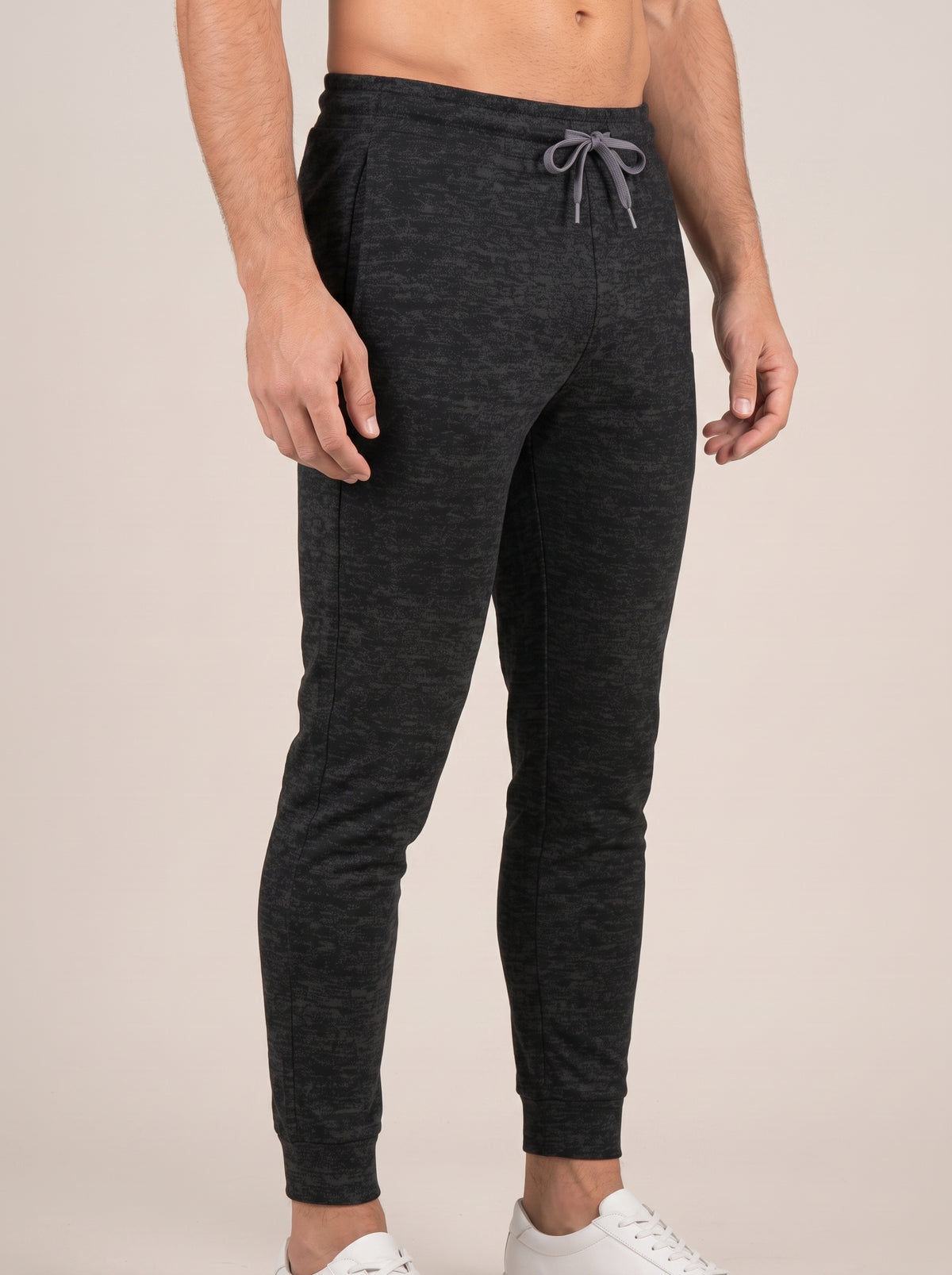 Charcoal heather FIT APE men's joggers on a model, angled front view
