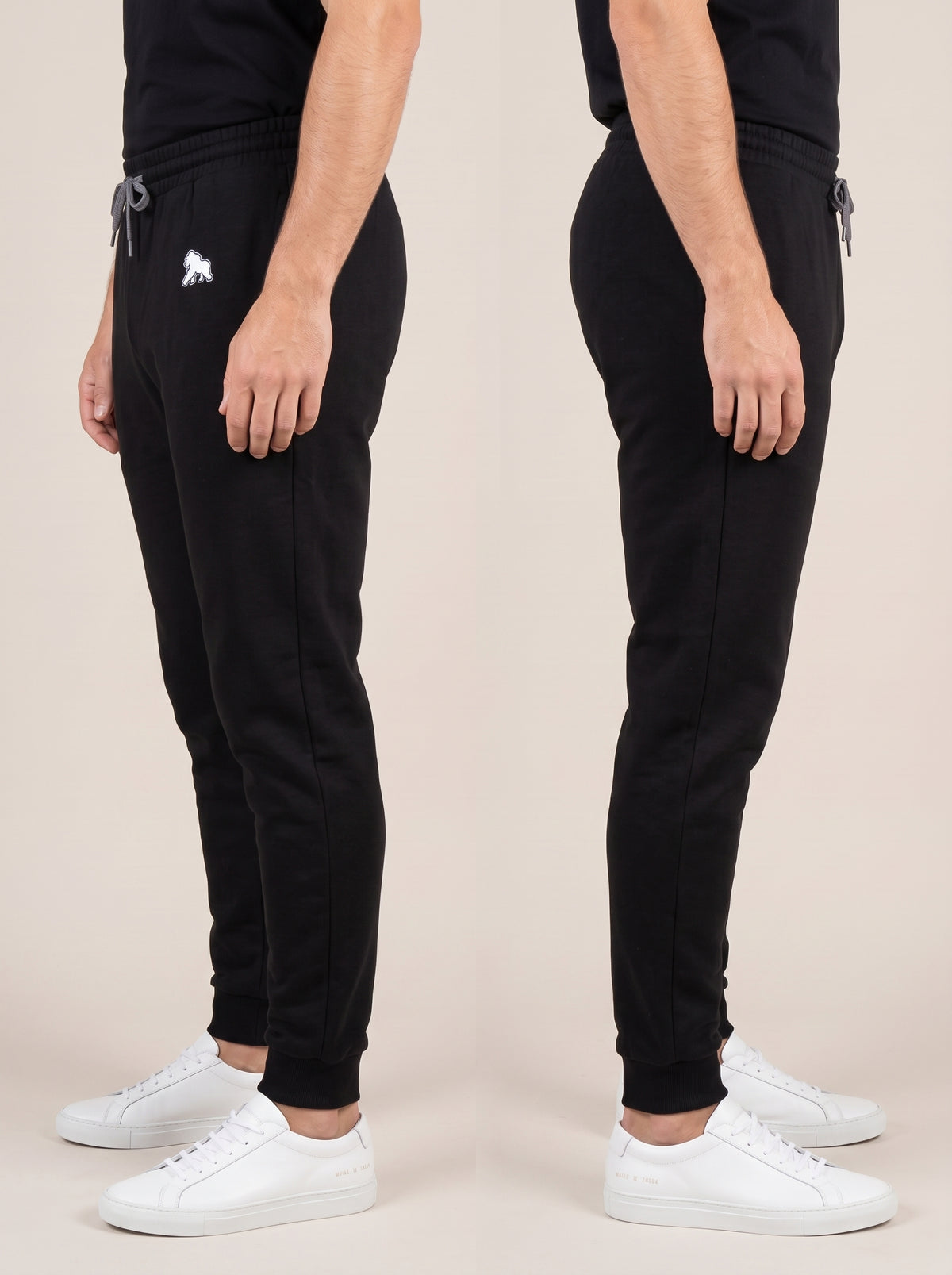 Black FIT APE men's joggers shown from both sides on a model