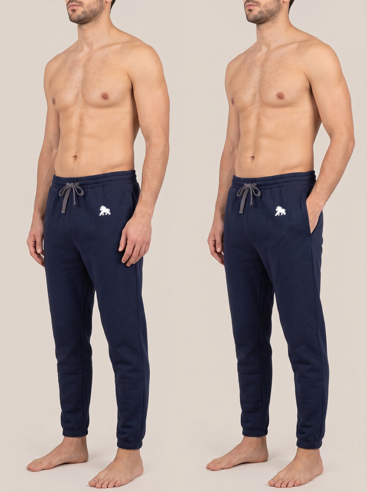 Navy FIT APE men's joggers shown in two standing poses on a model