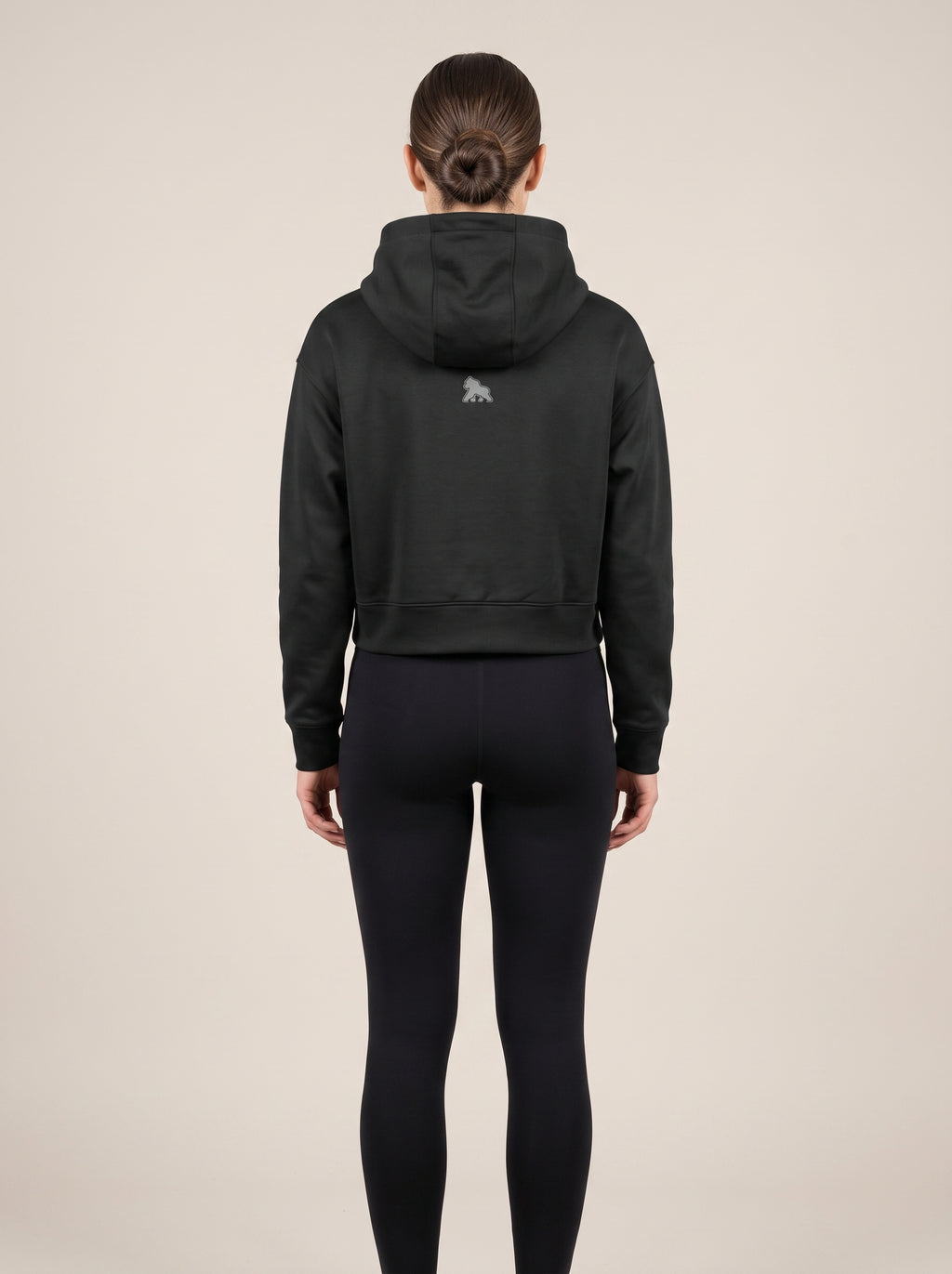 Black FIT APE women's cropped hoodie on a model, back view