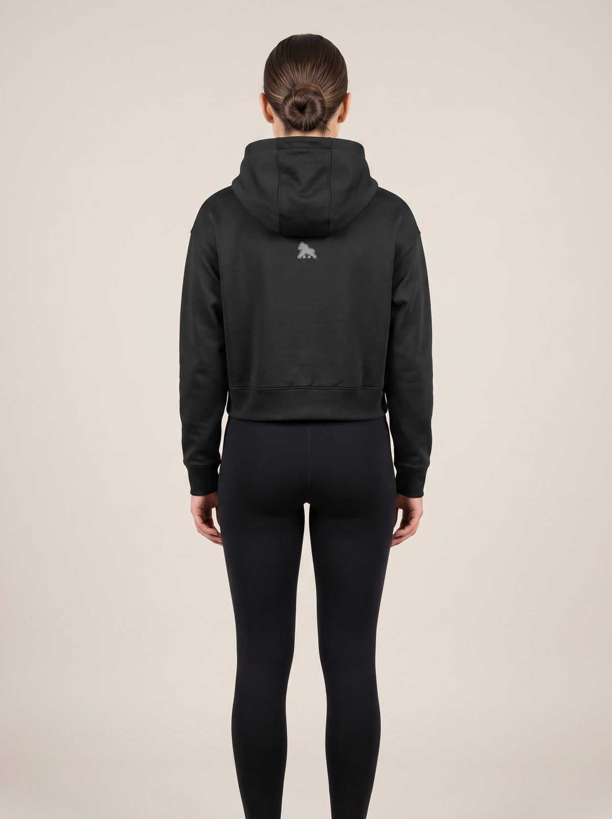 Black FIT APE women's cropped hoodie on a model, back view