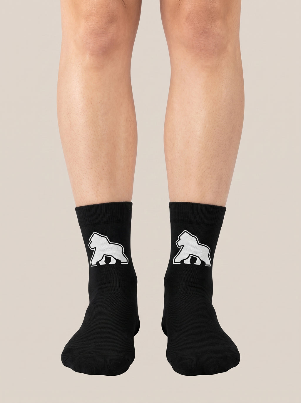 Black FIT APE crew socks worn on feet, front view with white gorilla emblems