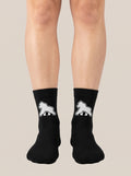 Black FIT APE crew socks worn on feet, front view with white gorilla emblems