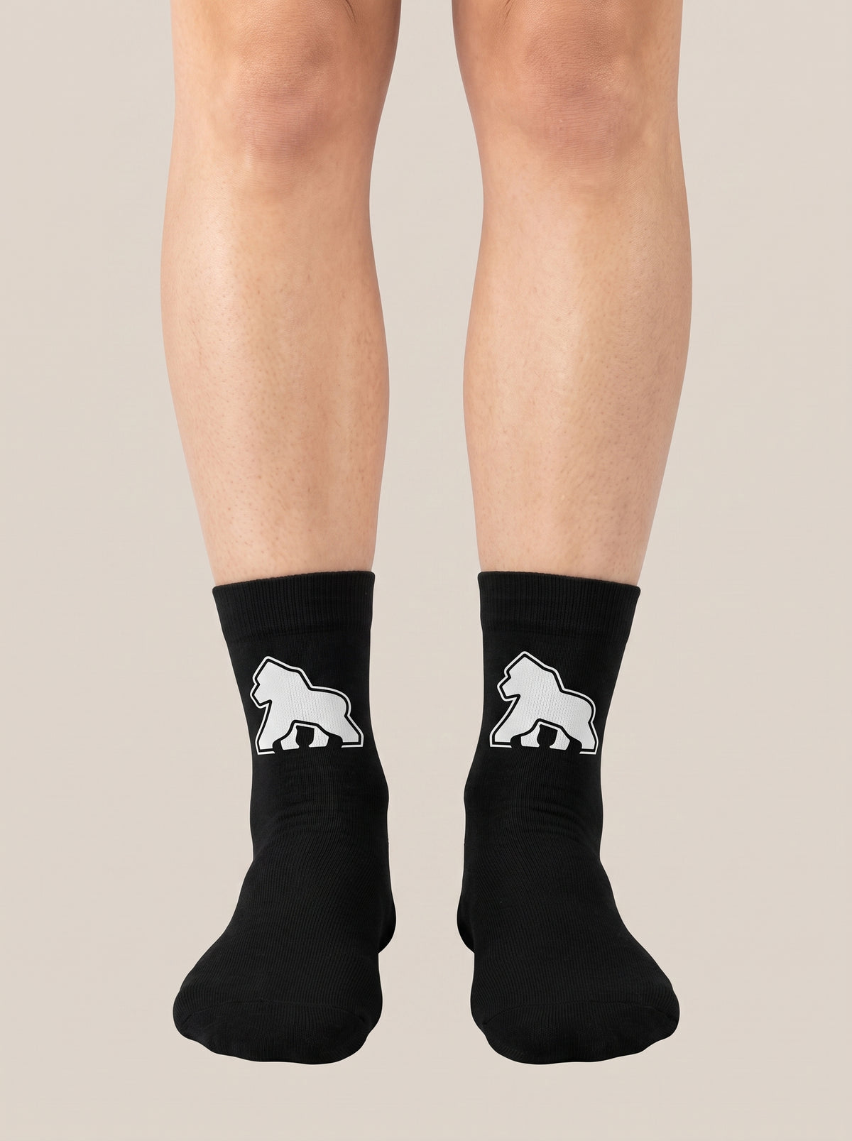 Black FIT APE crew socks worn on feet, front view with white gorilla emblems