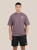 Muted purple FIT APE men's oversized tee on a model, front view