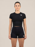Black FIT APE women's cropped performance top on a model, front view