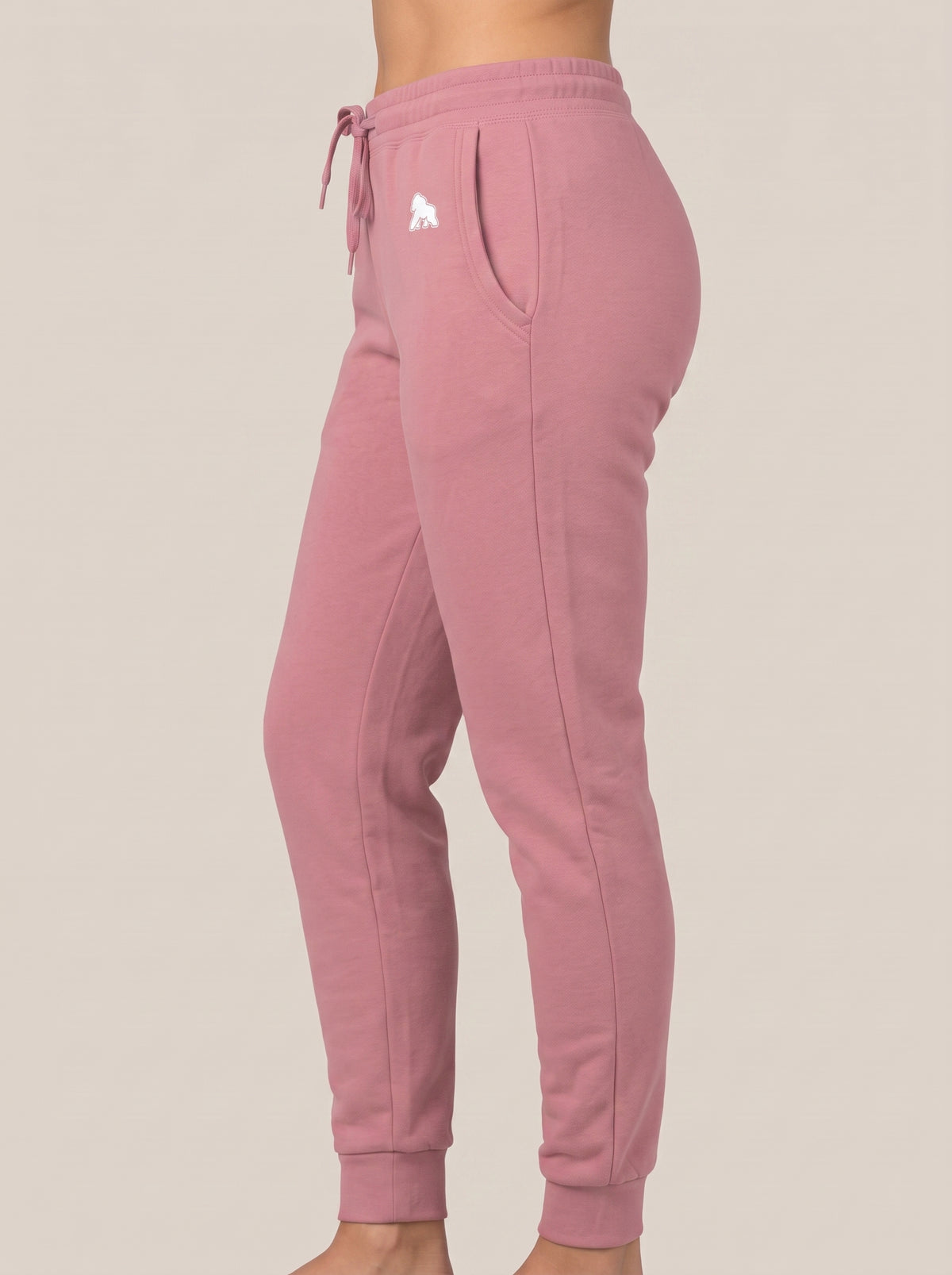 Pink FIT APE women's drawstring sweatpants, side view on a model
