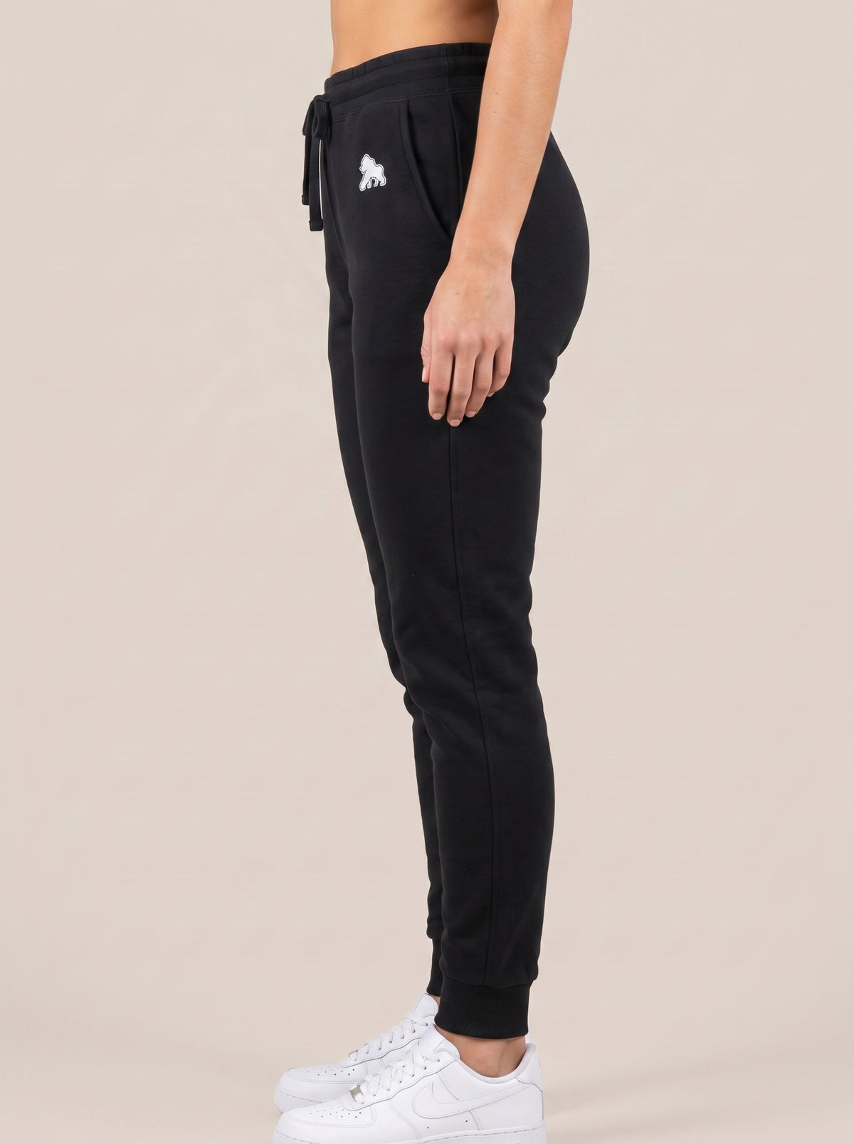 Black FIT APE women's drawstring sweatpants, side view on a model