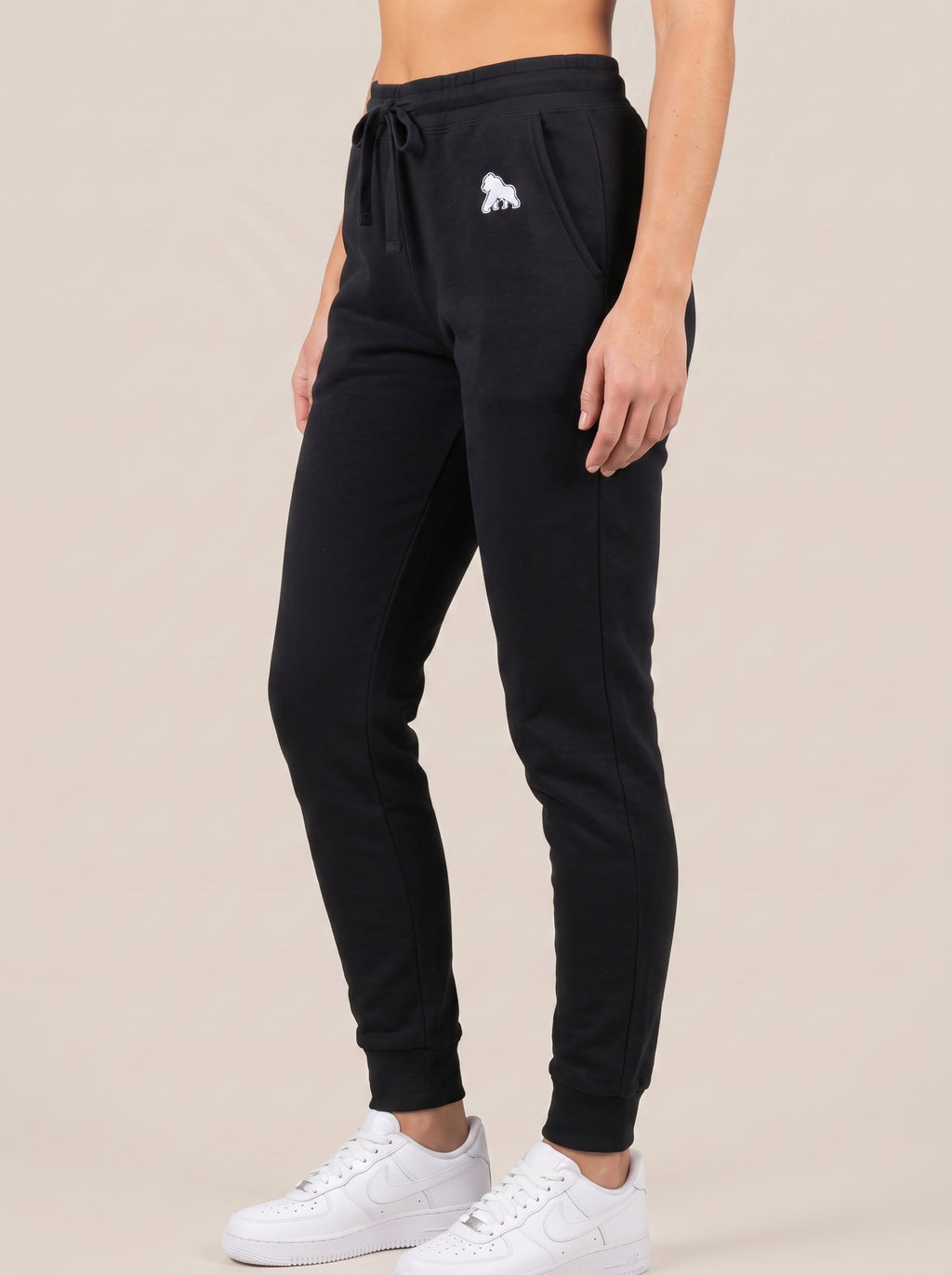Black FIT APE women's drawstring sweatpants, angled front view on a model