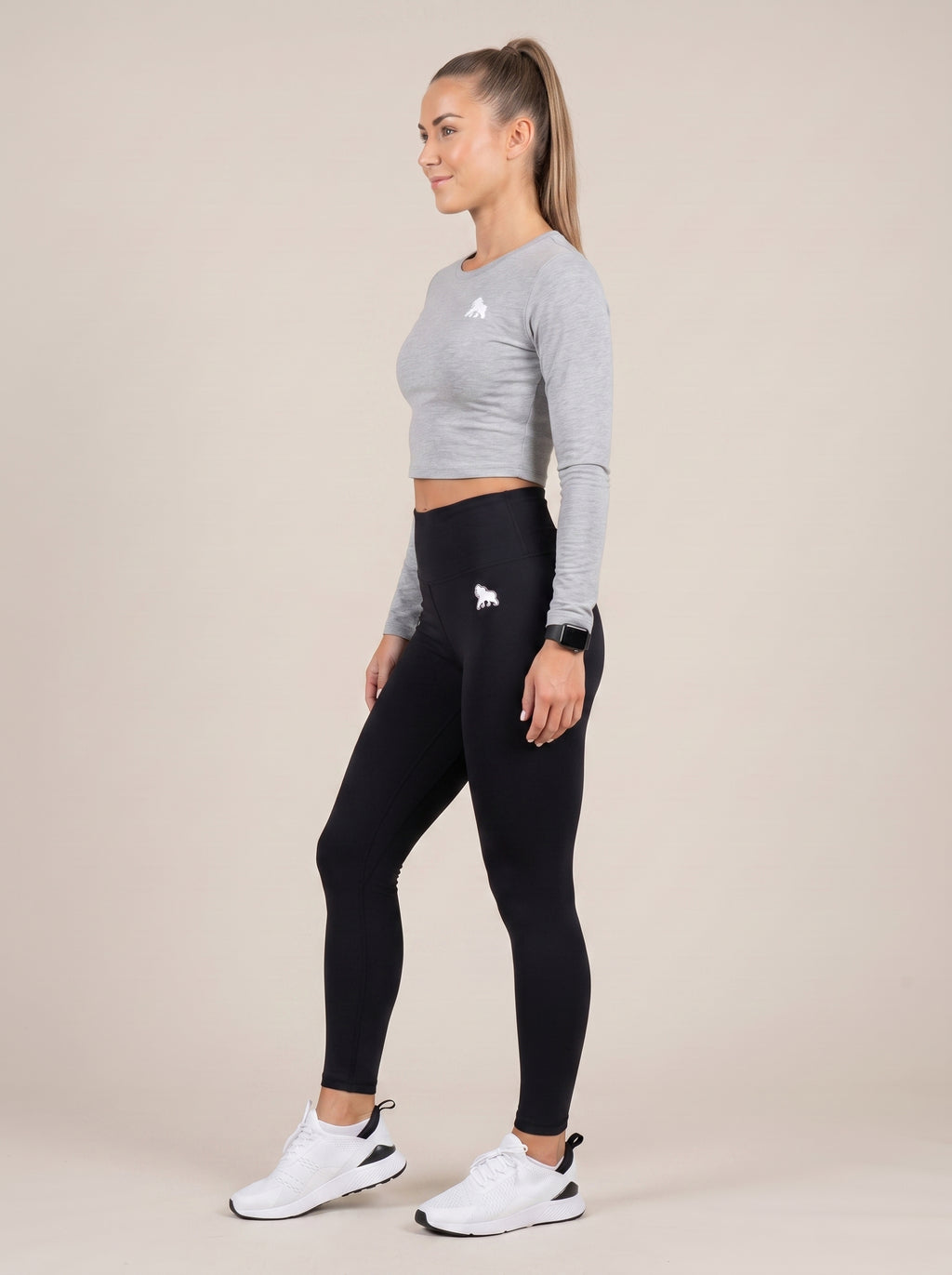 Gray FIT APE women's compression crop top on a model, side view