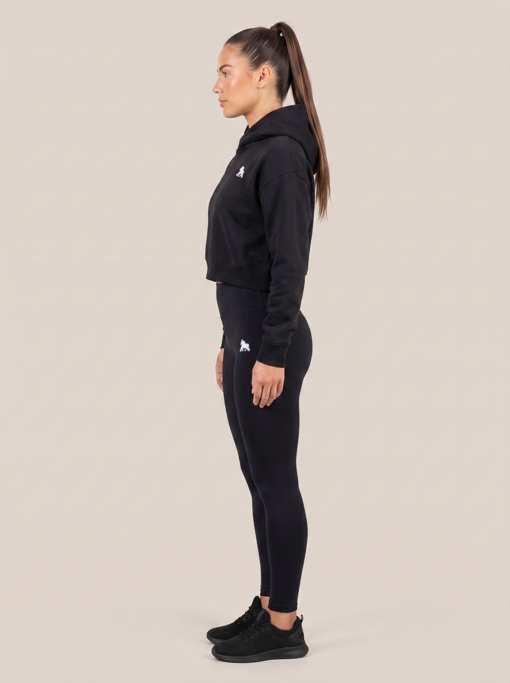 Black FIT APE women's cropped hoodie on a model, side view