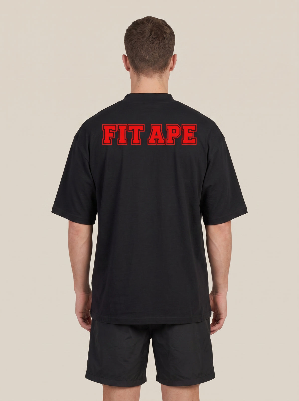 Black FIT APE men's classic tee with large red back lettering, rear view on a model
