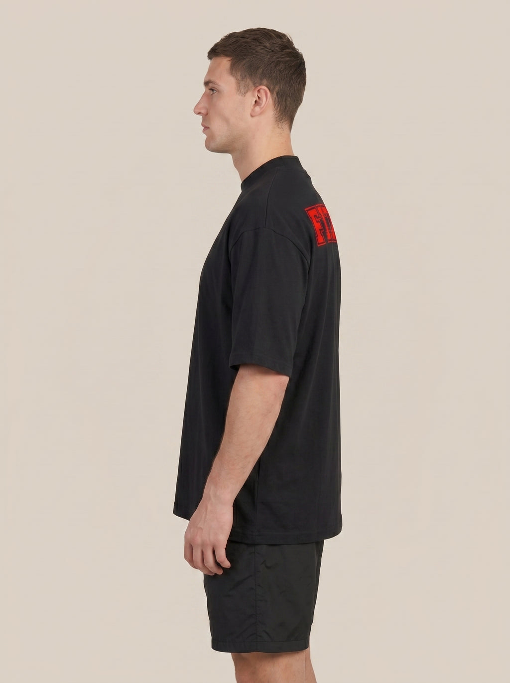 Black FIT APE men's classic tee on a model, side view