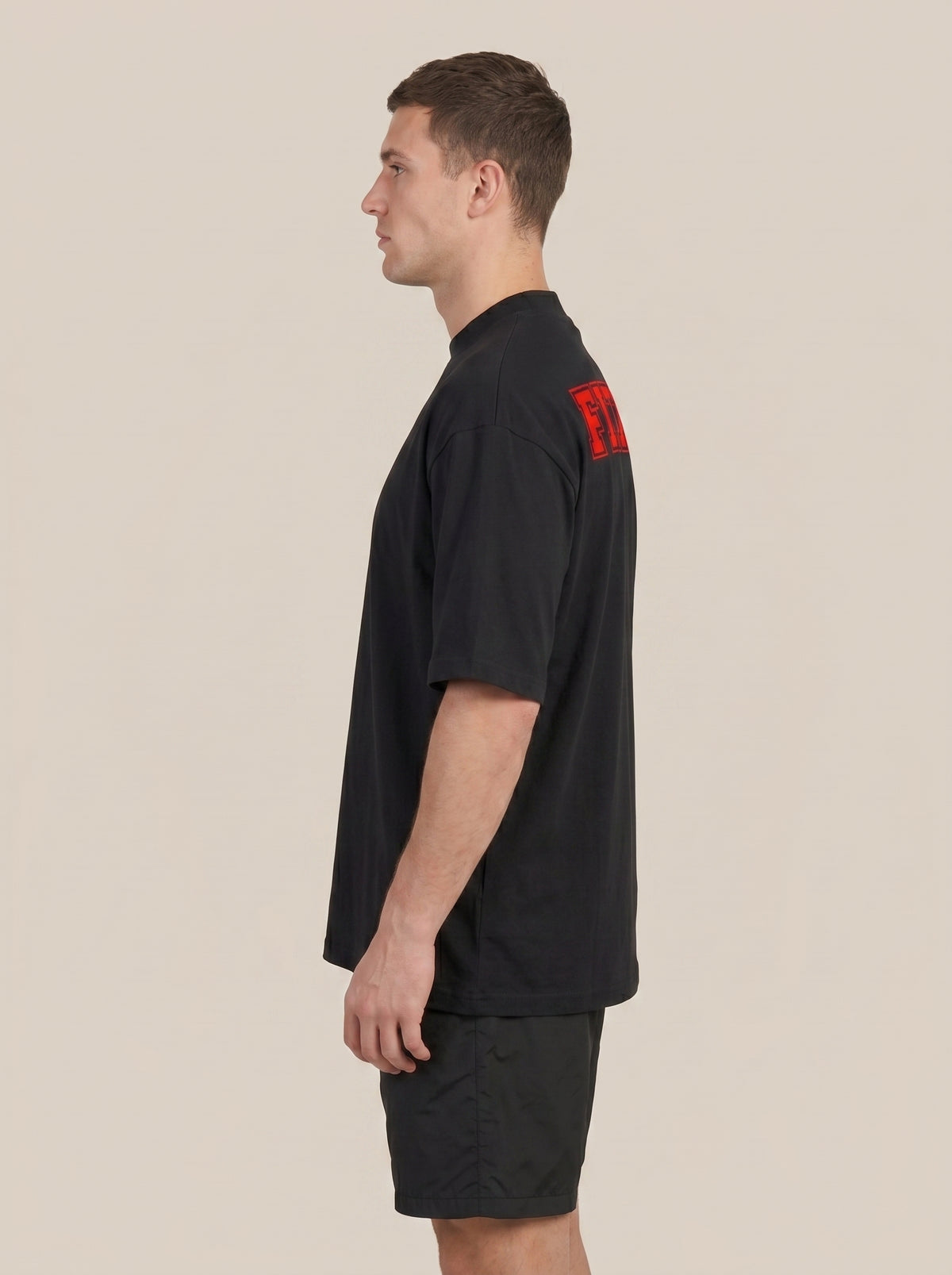 Black FIT APE men's classic tee on a model, side view