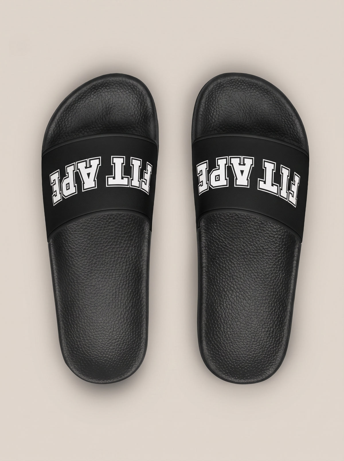 Pair of black women's FIT APE slides with toes pointing away, top view