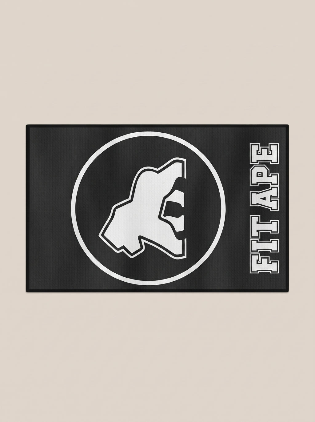 Black FIT APE gym towel with a white gorilla emblem and lettering, horizontal view