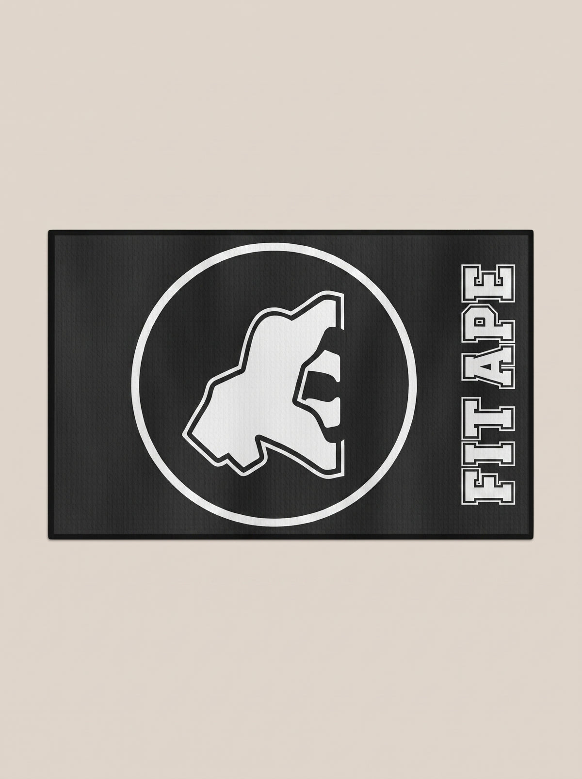 Black FIT APE gym towel with a white gorilla emblem and lettering, horizontal view