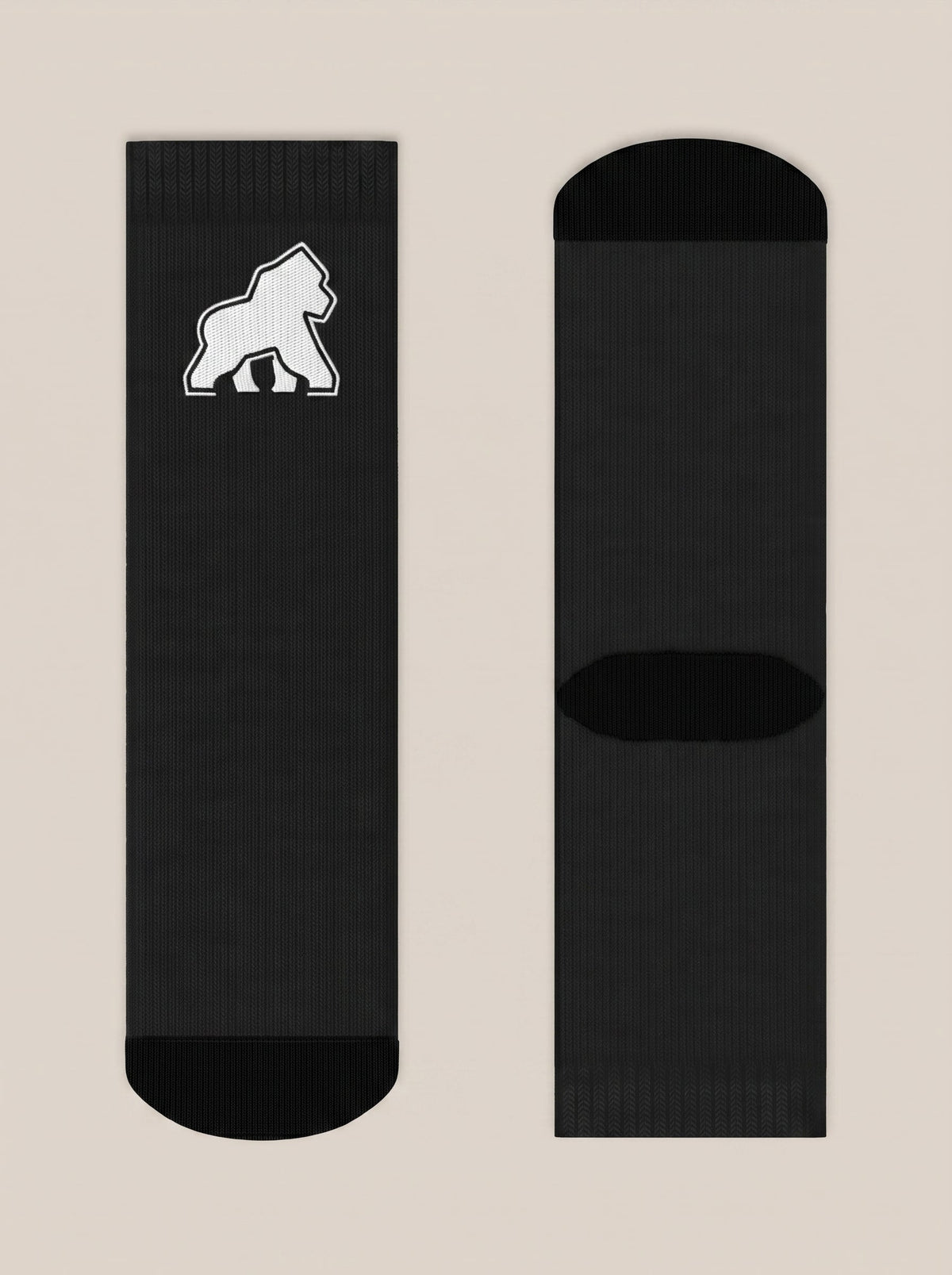 Pair of black FIT APE crew socks laid flat with white gorilla emblem
