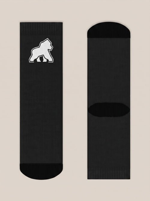 Pair of black FIT APE crew socks laid flat with white gorilla emblem